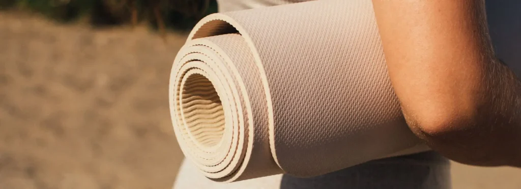 Woman holding a yoga mat